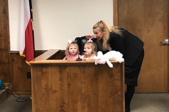 children with women in courtroom
